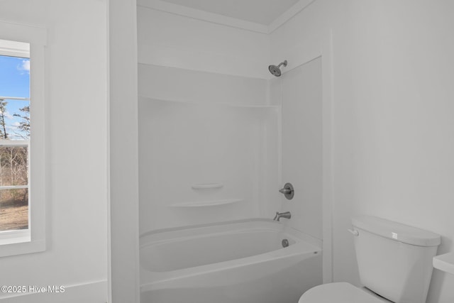 bathroom with shower / washtub combination and toilet