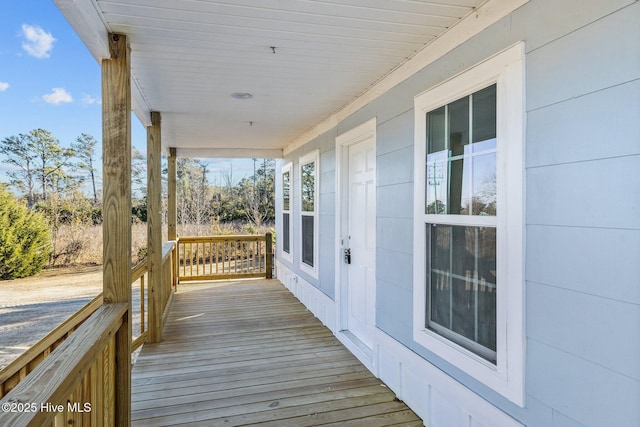 wooden terrace featuring covered porch