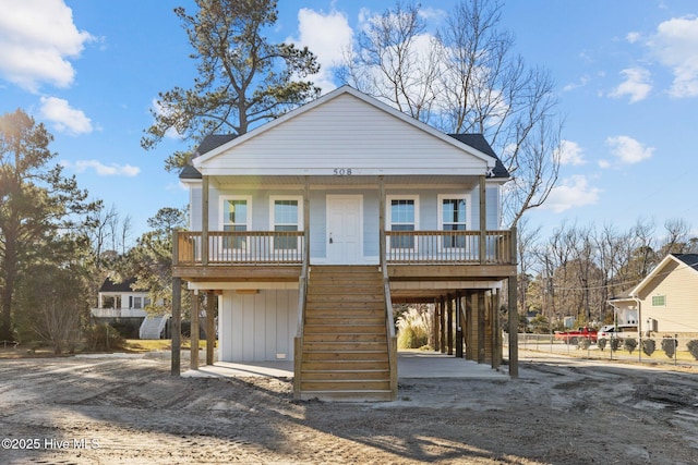 view of front facade featuring covered porch and a carport