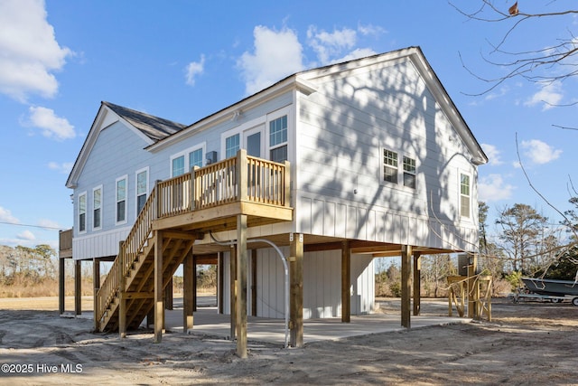 rear view of house featuring a wooden deck