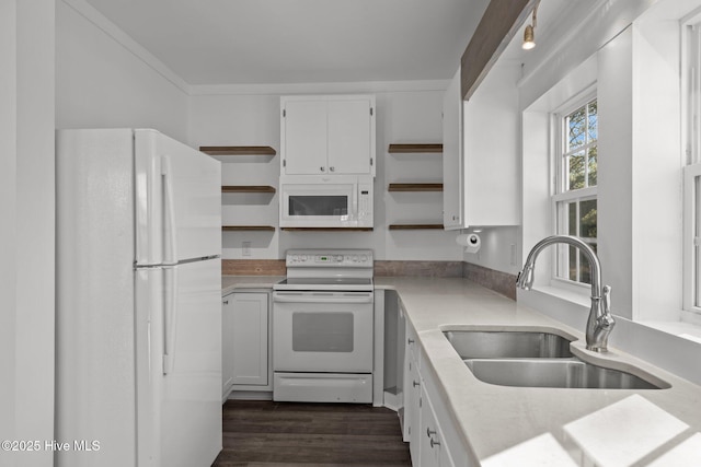 kitchen with white appliances, sink, dark hardwood / wood-style flooring, and white cabinets