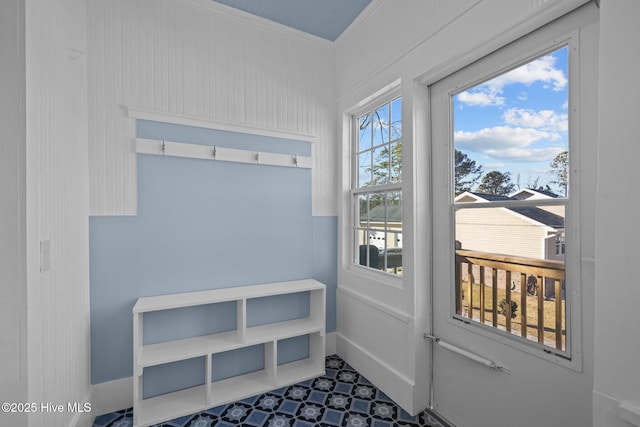 doorway to outside with ornamental molding