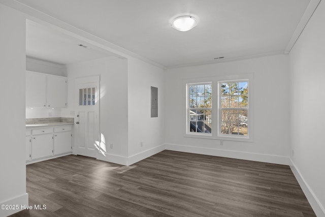 interior space with dark hardwood / wood-style floors and ornamental molding