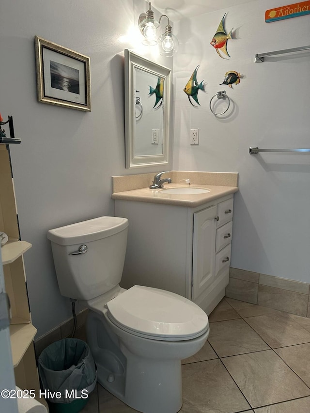 bathroom featuring tile patterned flooring, vanity, and toilet