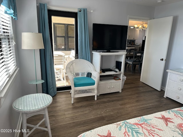 bedroom with dark hardwood / wood-style flooring and a notable chandelier