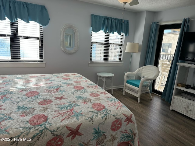 bedroom featuring a textured ceiling, ceiling fan, and dark wood-type flooring