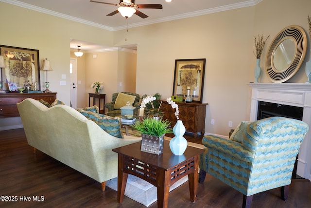 living room featuring ornamental molding, ceiling fan, and dark wood-type flooring