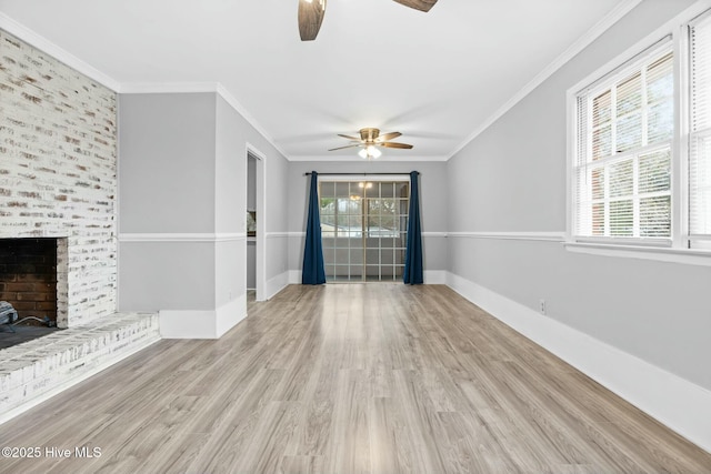 unfurnished living room featuring plenty of natural light, crown molding, and a fireplace