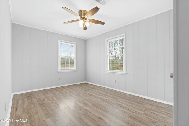 spare room featuring ceiling fan, light wood-type flooring, and crown molding