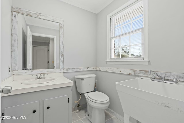 bathroom featuring tile patterned flooring, vanity, and toilet