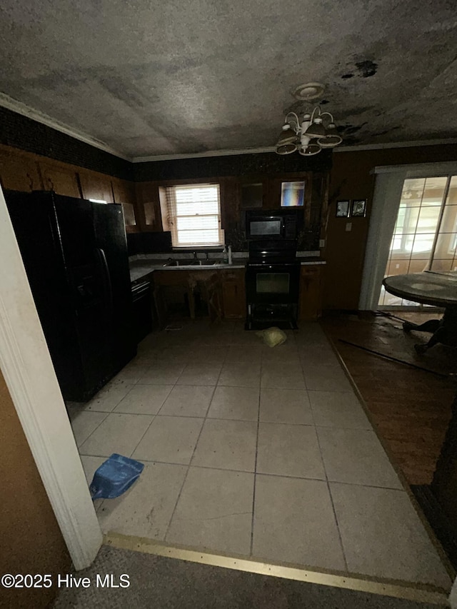 kitchen with black appliances and light tile patterned floors