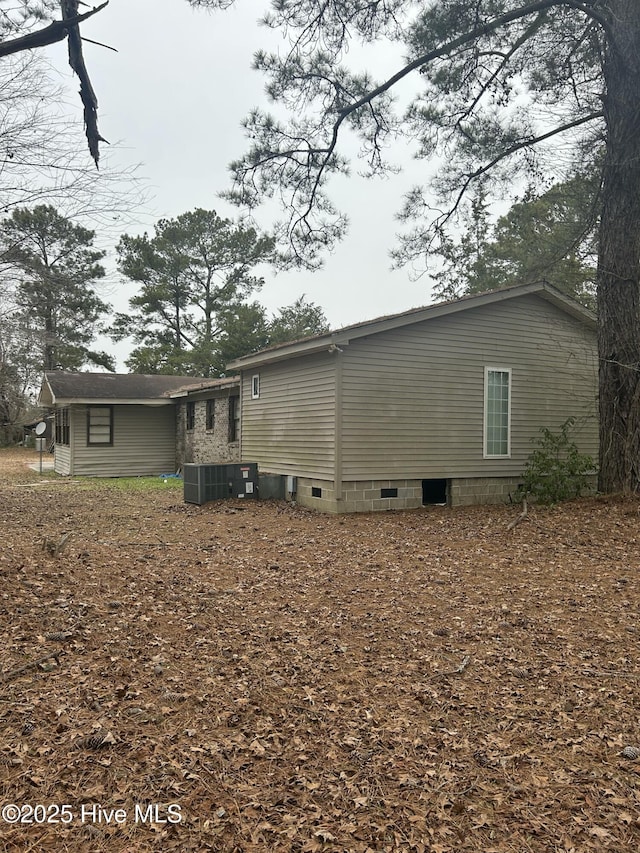 rear view of property with central air condition unit