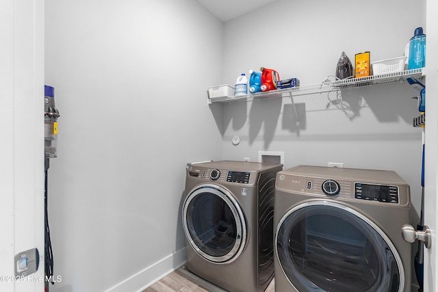 washroom featuring light wood-type flooring and washing machine and clothes dryer