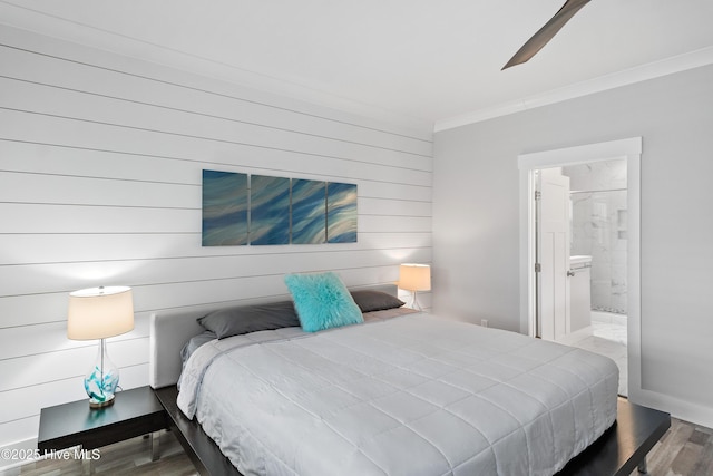 bedroom with ornamental molding, ceiling fan, wood-type flooring, and connected bathroom