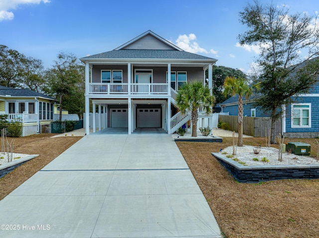 coastal inspired home with a garage and covered porch