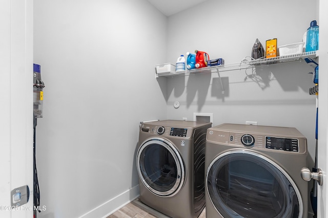 106 SE 36th St, Oak Island, NC 28465 - washroom with separate washer and dryer, wood finished floors, and baseboards