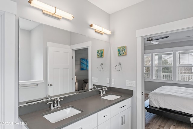 bathroom featuring ceiling fan, vanity, and wood-type flooring