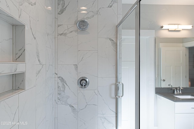 bathroom with vanity and a shower with shower door