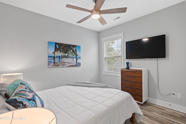 bedroom with ceiling fan and hardwood / wood-style flooring