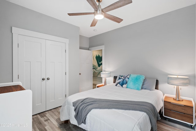 bedroom with ceiling fan, hardwood / wood-style floors, and a closet