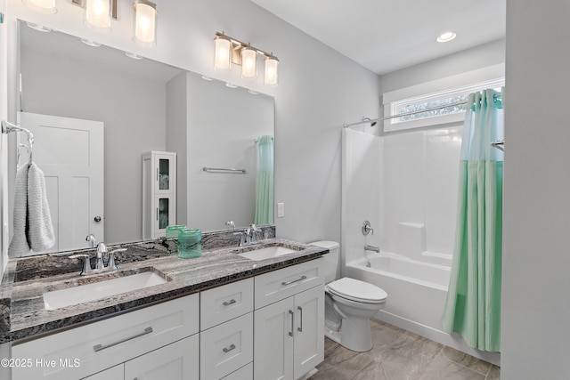 full bathroom featuring toilet, shower / bath combination with curtain, and vanity