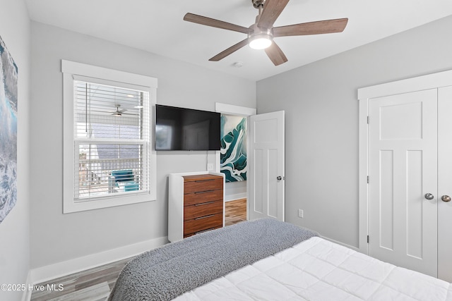 106 SE 36th St, Oak Island, NC 28465 - bedroom with wood finished floors, baseboards, and ceiling fan