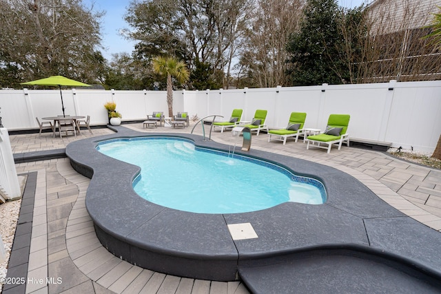 view of pool featuring pool water feature and a patio area