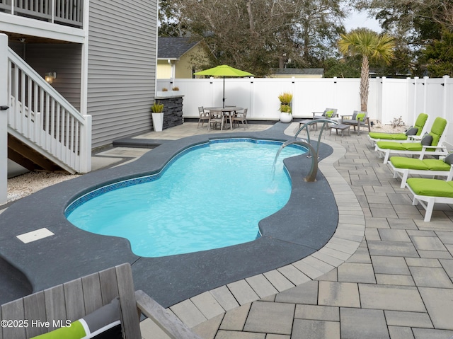 view of swimming pool with a patio