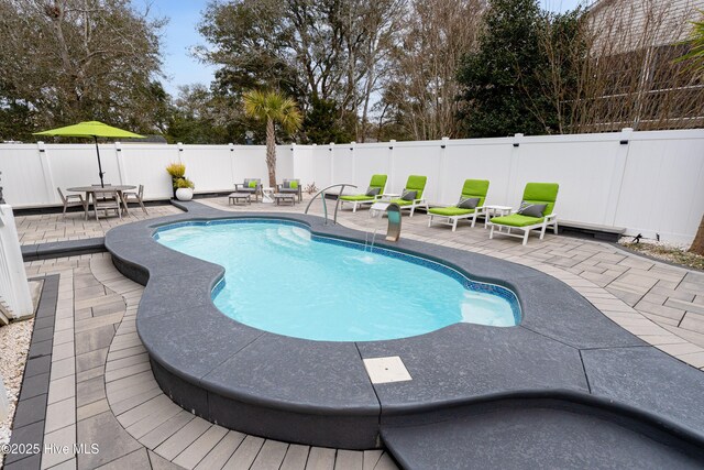 106 SE 36th St, Oak Island, NC 28465 - view of swimming pool featuring a patio area and a fenced backyard