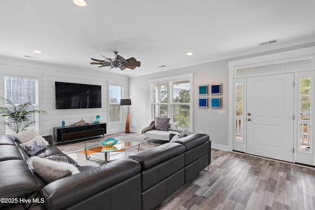 living room featuring ceiling fan and wood-type flooring