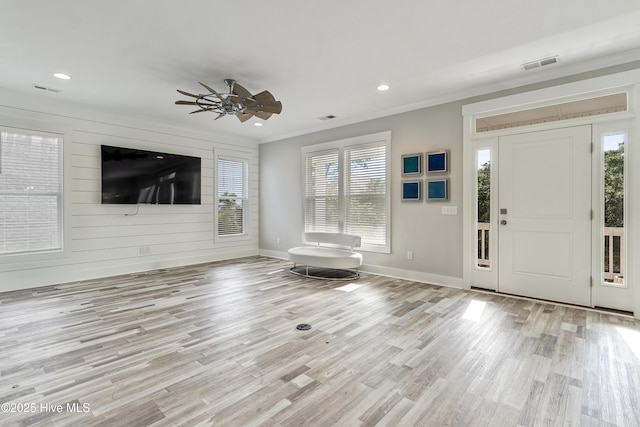 106 SE 36th St, Oak Island, NC 28465 - foyer featuring plenty of natural light, baseboards, wood finished floors, ornamental molding, and recessed lighting