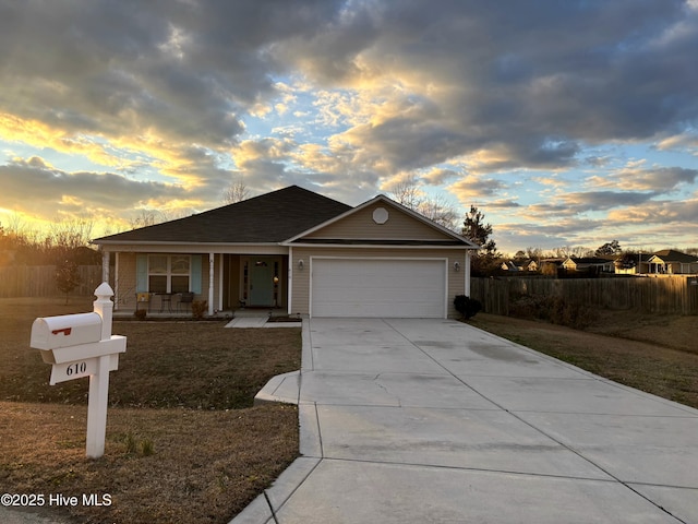 single story home featuring covered porch, a garage, and a lawn