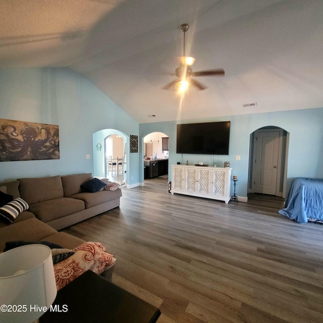 living room featuring ceiling fan, dark hardwood / wood-style flooring, and high vaulted ceiling