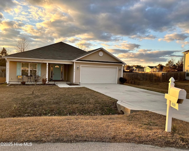 ranch-style home with a garage and a lawn