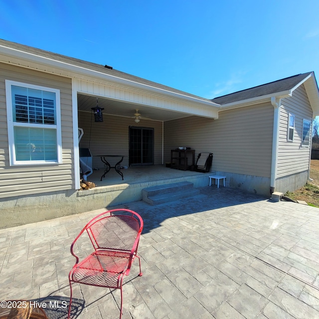 exterior space with ceiling fan and a patio area