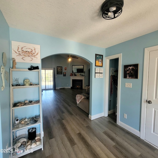 interior space with dark hardwood / wood-style floors and a textured ceiling