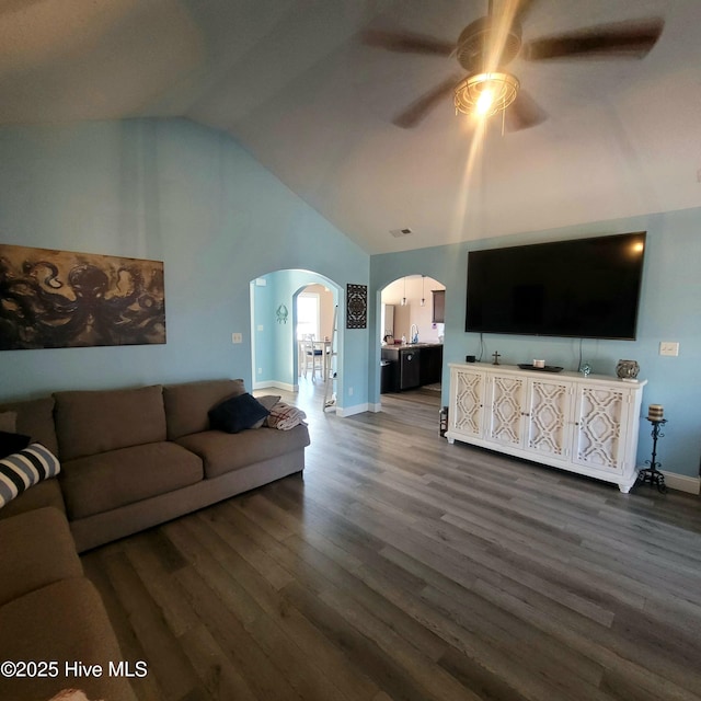 living room featuring dark wood-type flooring, ceiling fan, and high vaulted ceiling