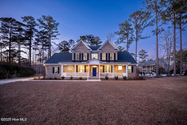 view of front of property with brick siding and covered porch