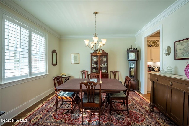 dining space featuring a notable chandelier, crown molding, baseboards, and dark wood-style flooring