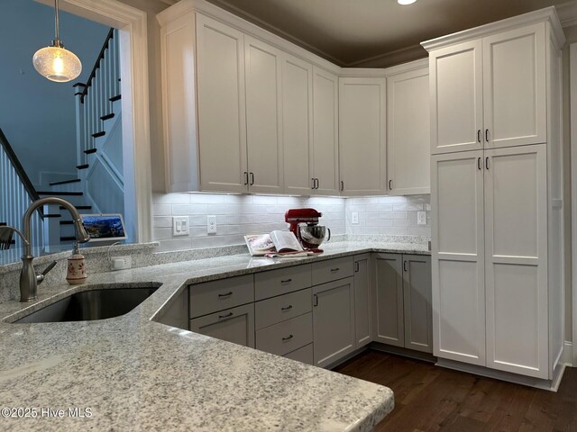 kitchen featuring visible vents, a sink, wooden counters, ornamental molding, and dark wood-style flooring