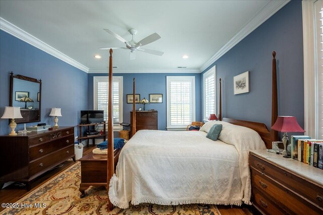 bedroom with multiple windows, crown molding, ceiling fan, and wood finished floors