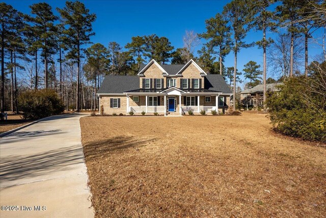 rear view of house with central AC unit, a sunroom, and a yard