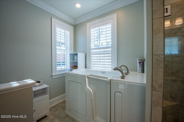 laundry area featuring tile patterned flooring, a healthy amount of sunlight, baseboards, and ornamental molding