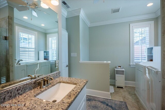 full bath with washer and dryer, visible vents, baseboards, and crown molding