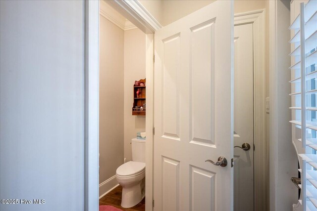 bathroom featuring toilet and baseboards