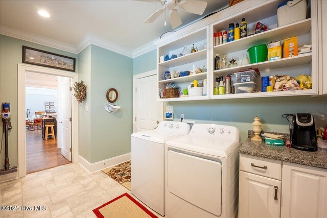 laundry room with baseboards, washing machine and dryer, ornamental molding, cabinet space, and a ceiling fan