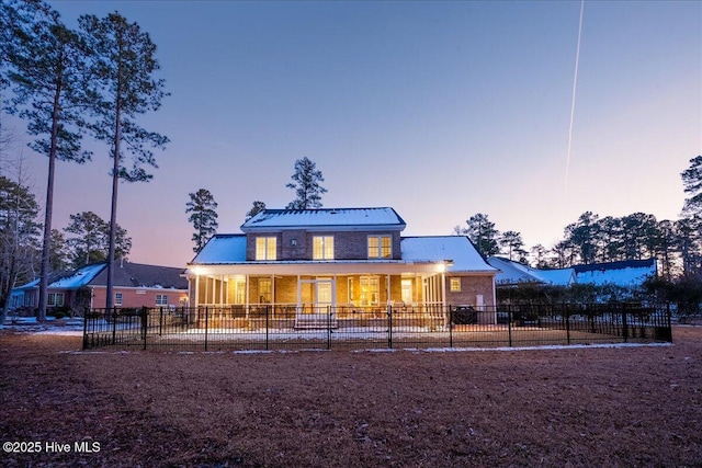 view of front facade with fence and brick siding