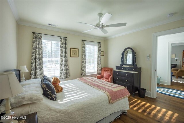 bedroom featuring visible vents, multiple windows, dark wood-style flooring, and crown molding