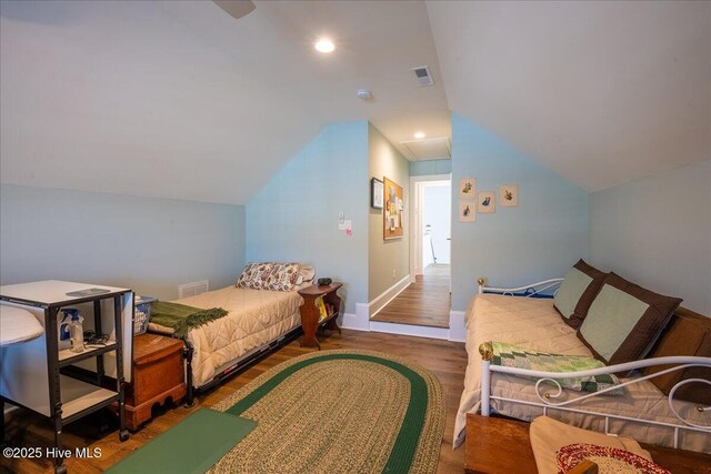 bedroom with visible vents, recessed lighting, lofted ceiling, and wood finished floors