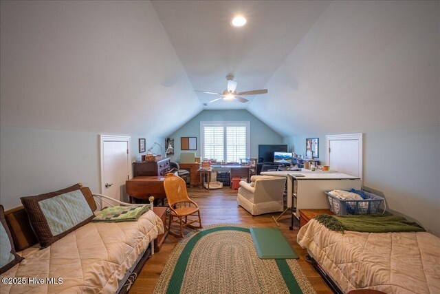 bedroom featuring lofted ceiling, wood finished floors, and a ceiling fan